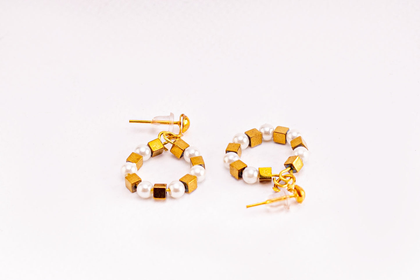 Earrings of white beads and metal