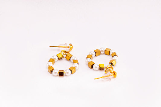 Earrings of white beads and metal