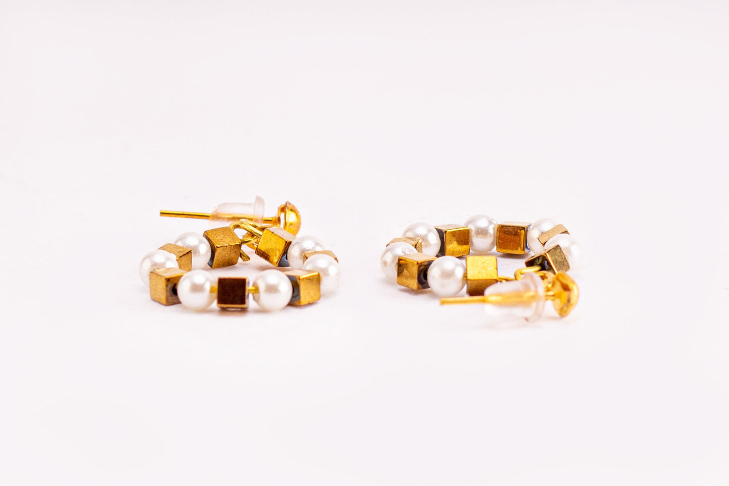 Earrings of white beads and metal